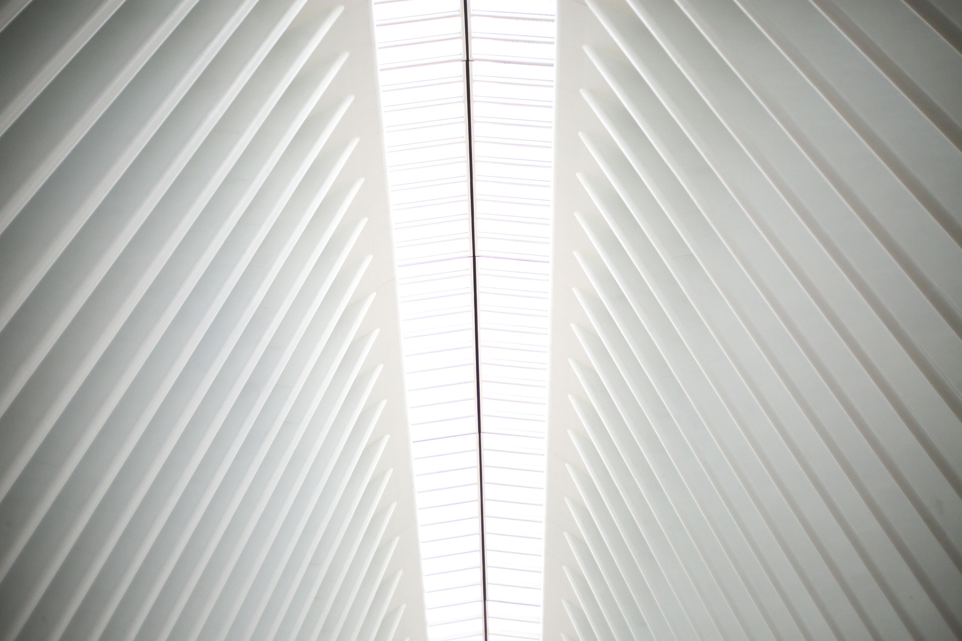 A ribbed white structure rising to a bright seam of light